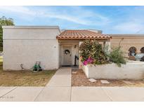 Charming front entrance with a tiled roof and a walkway leading to the front door and a well-maintained flower garden at 870 S Palm Ln # 55, Chandler, AZ 85225