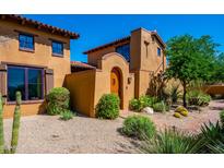 Charming Southwestern home featuring stucco walls, a tile roof, and desert landscaping at 10597 E Rising Sun Dr, Scottsdale, AZ 85262