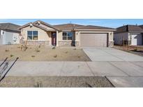 Inviting single-story home featuring a neutral color palette, desert landscaping, and an attached two-car garage at 14756 W Tether Trl, Surprise, AZ 85387