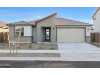 Charming single-story home with neutral tones, desert landscaping, and a convenient two-car garage at 14787 W El Cortez Pl, Surprise, AZ 85387