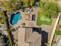 Aerial view of the private backyard featuring a pool, pergola, putting green, and lounge area at 1644 N Lynch --, Mesa, AZ 85207