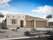Inviting single-story home showcasing a three-car garage, desert landscaping, and a neutral color palette at 18447 W Mohave St, Goodyear, AZ 85338