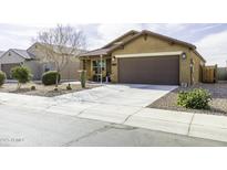 Inviting single-story home featuring a well-maintained yard with desert landscaping and a spacious two-car garage at 1973 N Lewis Pl, Casa Grande, AZ 85122