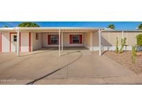 Wide angle of carport with red trim, concrete floor, and direct access to the home at 2400 E Baseline Ave # 278, Apache Junction, AZ 85119