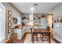 Charming kitchen with wooden countertops, open shelving, and decorative accents at 2402 E 5Th St # 1742, Tempe, AZ 85288