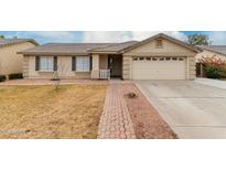 Charming single-level home featuring a tile roof and a well-maintained front yard at 2975 E Tulsa St, Gilbert, AZ 85295
