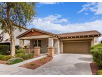 Charming single-story home with a two car garage, landscaped yard, and inviting covered porch at 3143 N Evergreen St, Buckeye, AZ 85396
