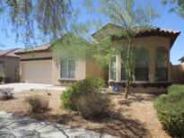 Charming single-story home featuring a well-maintained yard with desert landscaping and an attached two-car garage at 32020 N 23Rd Ave, Phoenix, AZ 85085