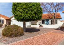 Charming single-story home featuring mature trees, desert landscaping, and a welcoming front entrance at 4558 E Rock Wren Rd, Phoenix, AZ 85044