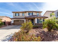 Two-story home with a two-car garage and a beautiful desert-landscaped front yard at 4727 S Watauga Dr, Gilbert, AZ 85297