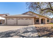 Charming single-story home featuring a three-car garage and a well-maintained front yard at 5025 N 85Th Dr, Glendale, AZ 85305