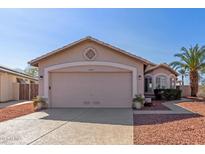 Charming single-story home with a two-car garage and desert landscaping at 10659 W Yukon Dr, Peoria, AZ 85382