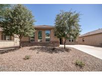 Charming single-story home featuring desert landscaping and stone accents on the facade at 10859 E Thatcher Ave, Mesa, AZ 85212