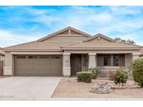 Charming single-story home boasts a two-car garage, neutral exterior, and low-maintenance desert landscaping at 1261 E Nancy Ave, San Tan Valley, AZ 85140