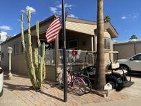 Charming home featuring desert landscaping, golf cart, and covered porch in a friendly community at 1277 S Shawnee Dr, Apache Junction, AZ 85119