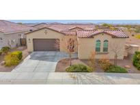 Charming single-story home featuring a well-maintained yard, desert landscaping, and a two-car garage at 18059 W Tanglewood Dr, Goodyear, AZ 85338