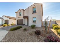 Two-story home with a two car garage and low maintenance desert landscaping at 3193 E Rebel E Ln, San Tan Valley, AZ 85143