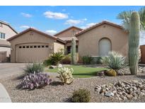 Charming single-story home featuring a well-manicured desert landscape and attached two-car garage at 4021 S Tumbleweed Ct, Chandler, AZ 85248