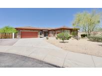 Charming single-story home featuring a well-manicured desert landscape, a spacious driveway, and a two-car garage at 4116 E Sierra Sunset Trl, Cave Creek, AZ 85331
