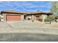 Beautiful single-story home with stone accents, a tile roof, a multi-car garage, and mature landscaping at 4116 E Sierra Sunset Trl, Cave Creek, AZ 85331