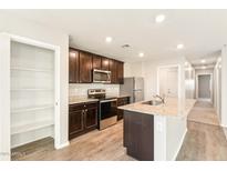 Kitchen island with granite countertops and stainless steel appliances at 431 W Guinea Ct, Casa Grande, AZ 85122