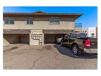 Apartment building with parking spaces and visible cars at 4714 E Belleview St, Phoenix, AZ 85008