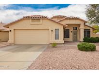 Charming single-story home featuring a tile roof and a two-car garage at 9859 W Irma Ln, Peoria, AZ 85382