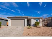 Charming single-story home boasts a neutral palette, attached garage, and low maintenance landscaping at 13342 W Lariat Ln, Peoria, AZ 85383