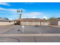 Charming single-story home featuring desert landscaping, solar panels and a private front patio at 1434 N Casa Grande Ave, Casa Grande, AZ 85122