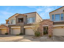 Beautiful townhome exterior with stone accents, multiple garages, and desert landscaping at 19550 N Grayhawk Dr # 2038, Scottsdale, AZ 85255