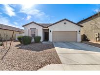 Charming single-story home with a well-manicured front yard and a spacious two-car garage at 20183 W Monroe St, Buckeye, AZ 85326