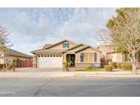 Charming single-story home with a well-manicured lawn, a two-car garage, and inviting curb appeal at 20742 E Mockingbird Dr, Queen Creek, AZ 85142