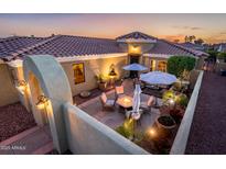 Cozy courtyard with desert landscaping, a water fountain, and comfortable seating areas at 23236 N Caleta Ct, Sun City West, AZ 85375