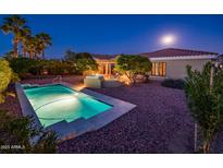 An exterior shot of a private pool with desert landscaping and ample backyard space at 23236 N Caleta Ct, Sun City West, AZ 85375