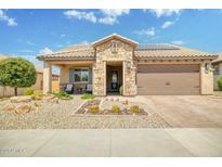 Charming single-story home with stone accents, a well-manicured desert landscape, and a two-car garage at 26578 W Piute Ave, Buckeye, AZ 85396