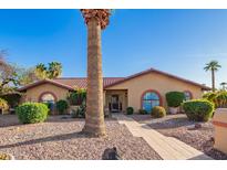 Charming single-story home features a tile roof, arched windows, and a beautifully xeriscaped front yard with mature landscaping at 315 W Sonoma Dr, Litchfield Park, AZ 85340