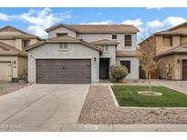 Charming two-story home with a well-maintained front yard and two car garage at 342 E Backman St, San Tan Valley, AZ 85140