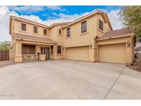 Charming two-story home featuring a three-car garage and a well-maintained, light-colored exterior at 38274 N Tumbleweed Ln, San Tan Valley, AZ 85140