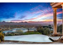 Infinity pool with panoramic views of the desert landscape at sunset at 42613 N 111Th Pl, Scottsdale, AZ 85262