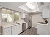 Modern kitchen with stainless steel appliances and bright white countertops at 4703 N 26Th Ln, Phoenix, AZ 85017