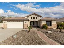 Charming single-story home with desert landscaping and a brick pathway to the entrance at 6060 W Charter Oak Rd, Glendale, AZ 85304