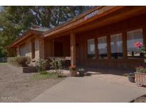 Charming single-story brick home with a covered front porch and well-maintained landscaping at 9620 S 156Th Pl, Gilbert, AZ 85234