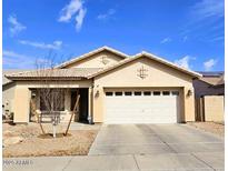 Charming single-story home featuring a well-maintained lawn, neutral-toned exterior, and a two-car garage at 12360 W Sherman St, Avondale, AZ 85323