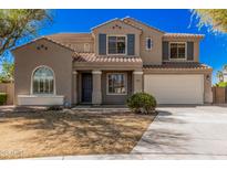 Charming two-story home featuring a well-manicured lawn and an attached two-car garage at 1481 E Lark St, Gilbert, AZ 85297