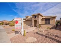 Charming single-story home boasts a stone-accented facade, three-car garage, and low-maintenance desert landscaping at 17846 W Fairview St, Goodyear, AZ 85338