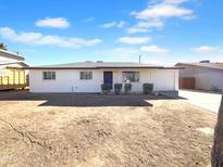 Charming single-story home with a fresh white exterior, dark roof, and minimalist landscaping at 1801 W 5Th Pl, Mesa, AZ 85201