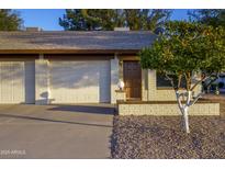 Charming home with attached two-car garage, a mature fruit tree, and well-maintained landscaping at 2064 S Farnsworth Dr # 43, Mesa, AZ 85209