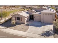 Charming single-story home boasts a three-car garage and a well-maintained desert landscape at 24847 N 175Th Dr, Surprise, AZ 85387