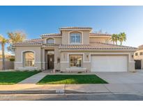 Beautiful two-story home with a well-manicured lawn, three car garage, and elegant design at 5433 E Nisbet Rd, Scottsdale, AZ 85254