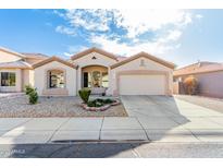 Charming single-story home featuring a two-car garage and well-maintained desert landscaping at 6009 W Questa Dr, Glendale, AZ 85310